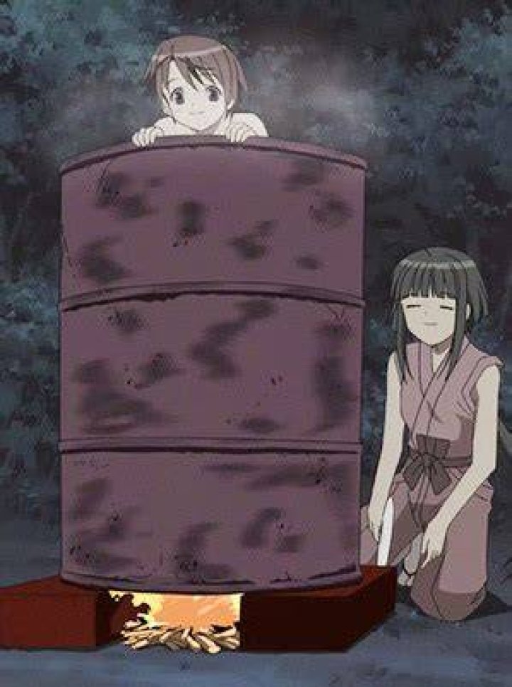 Lady bathing inside a drum of water. Lady bathing inside a drum of water.