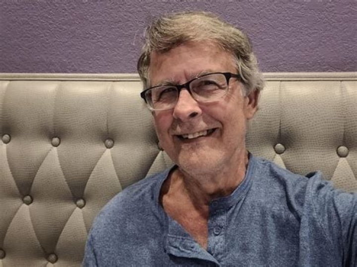 man smiling in restaurant booth