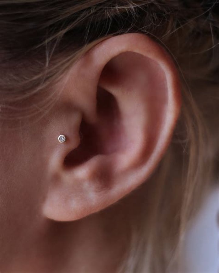 Tragus piercing with a stud earring (L) and in a love shaped earing (R) Tragus piercing with a stud earring (L) and in a love shaped earing (R)