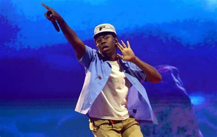 Tyler the Creator performing on stage Tyler the Creator performing on stage